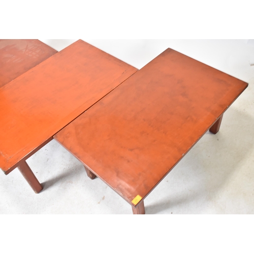 378 - A group of three 20th century red lacquered coffee / low tables. Each table having a rectangular top... 