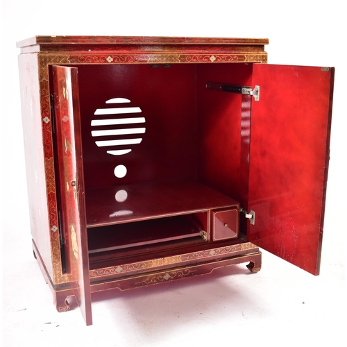 382 - A 20th century Japanese influence red lacquered media tv unit cabinet. The cabinet having a squared ... 