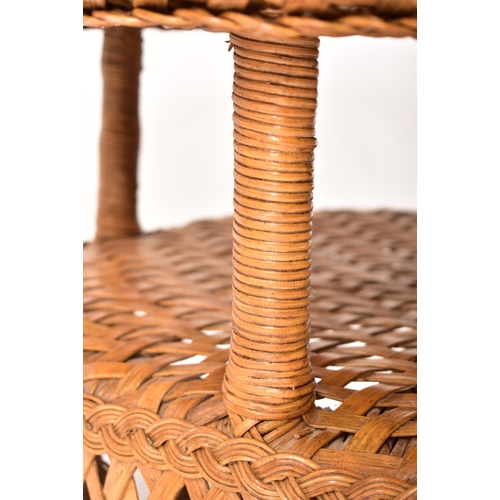 423 - A large 20th century bamboo and wicker woven coffee table / low table. The table having a circular t... 