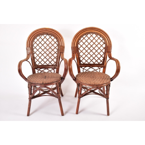 474 - A matching set of four 20th century wicker and rattan woven dining chairs / armchairs. Each chair ha... 