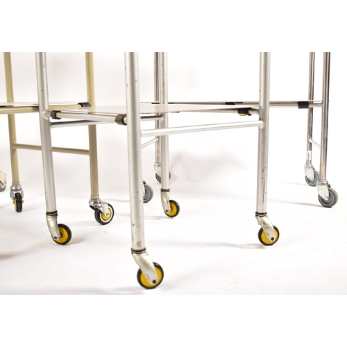 479 - A selection of four 20th century stainless steel medical / hospital trolleys. One trolley having two... 