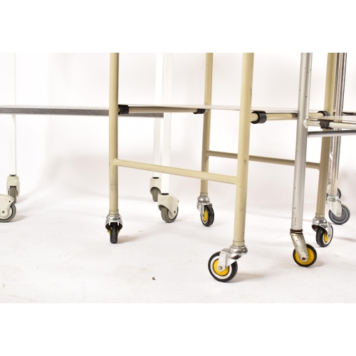 479 - A selection of four 20th century stainless steel medical / hospital trolleys. One trolley having two... 
