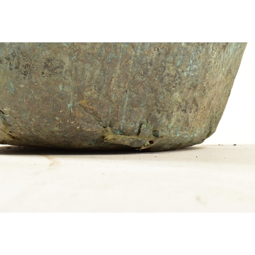 505 - A large late 19th century well weathered copper pot / garden planter. The pot of circular form with ... 