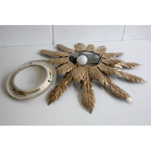 539 - A vintage 20th century Hollywood Regency sunburst wall light sconce. The light having a central conv... 