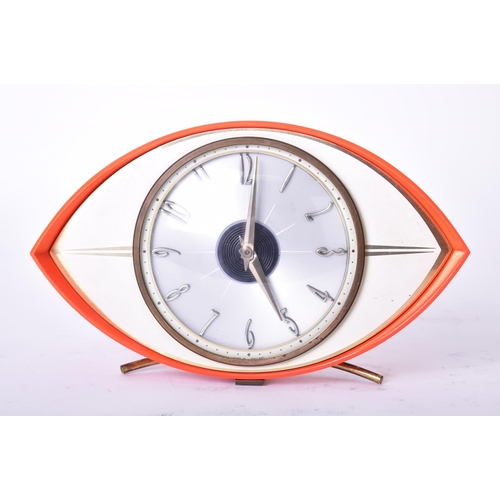 592 - Metamec - a vintage mid 20th century circa 1960s orange Bakelite atomic eye desk top clock. The cloc... 