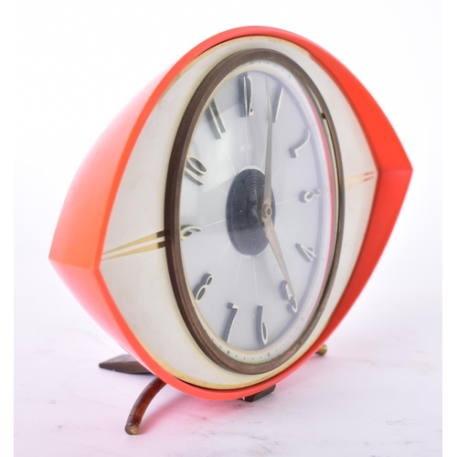 592 - Metamec - a vintage mid 20th century circa 1960s orange Bakelite atomic eye desk top clock. The cloc... 