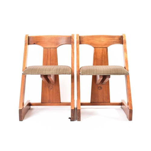 609 - A matching pair of 20th century pine framed chairs. Each chair having a yoke top rails with central ... 