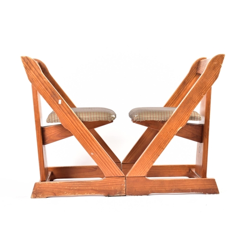 609 - A matching pair of 20th century pine framed chairs. Each chair having a yoke top rails with central ... 