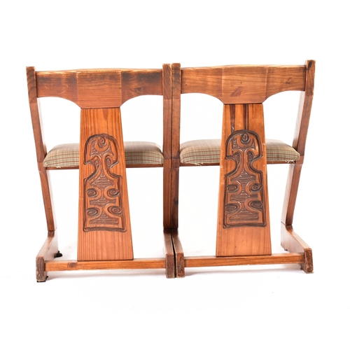 609 - A matching pair of 20th century pine framed chairs. Each chair having a yoke top rails with central ... 