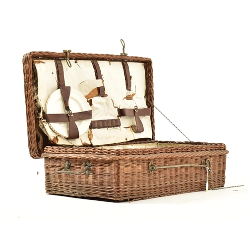 623 - An early 20th century circa 1920s six person Coracle wicker picnic basket. The basket opening to rev... 