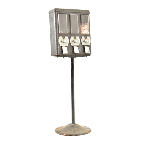 636 - A vintage 20th century three section sweet dispenser. Cast iron top with perspex covers and dispense... 