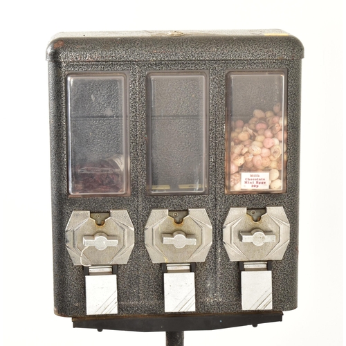 636 - A vintage 20th century three section sweet dispenser. Cast iron top with perspex covers and dispense... 