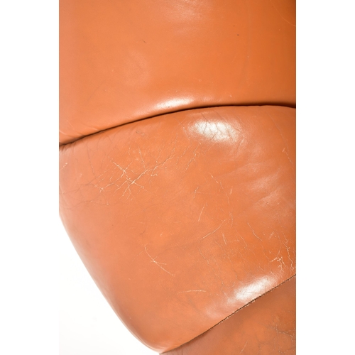 74 - A retro 20th century 1970s Art Deco influenced leather swivel lounge chair / armchair. The chair hav... 