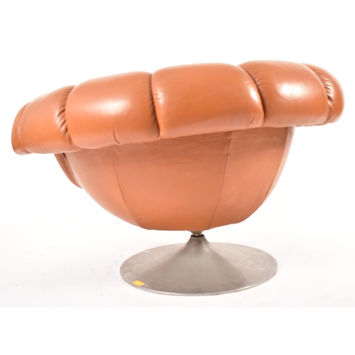 74 - A retro 20th century 1970s Art Deco influenced leather swivel lounge chair / armchair. The chair hav... 