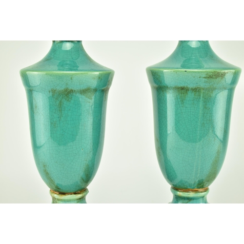 233 - A pair of turquoise / green crackle glazed urn style home interior decorative objects. Largest measu... 