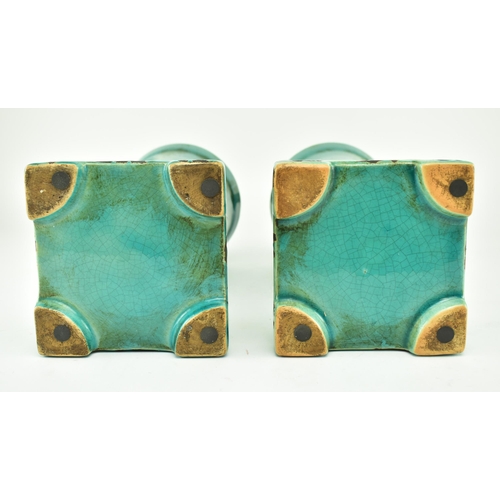 233 - A pair of turquoise / green crackle glazed urn style home interior decorative objects. Largest measu... 