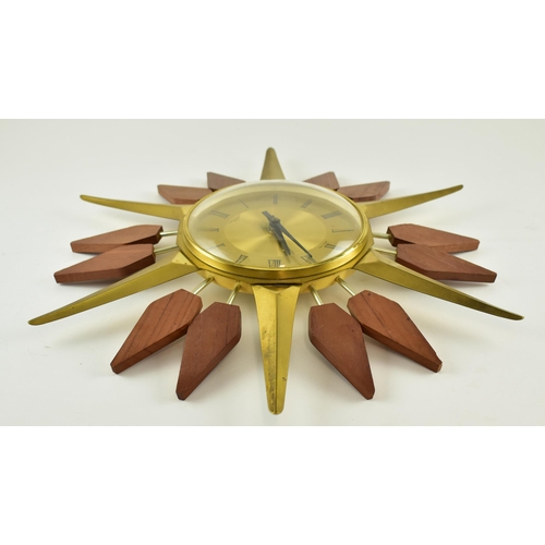 275 - A vintage mid century 1960s Anstey & Wilson Starburst wall clock. The clock of brass with teak wood ... 