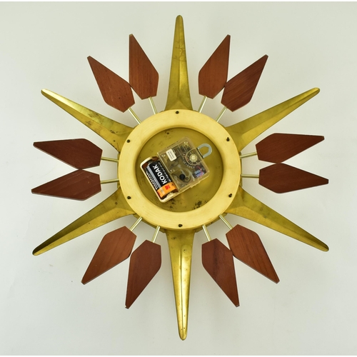 275 - A vintage mid century 1960s Anstey & Wilson Starburst wall clock. The clock of brass with teak wood ... 