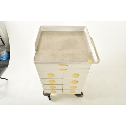 524 - A retro 20th century surgical / medical stainless steel and metal trolley. the trolley having a rais... 