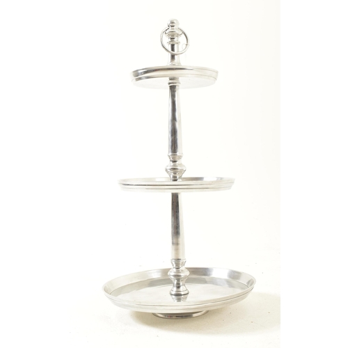 614 - A contemporary large three tier cake stand / food display stand. Central polished metal turned steam... 