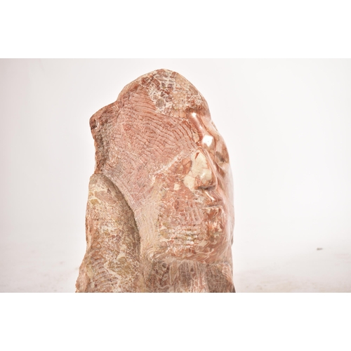 646 - A contemporary hand chiselled & polished pink marble conceptual floor sculpture statue. The sculptur... 