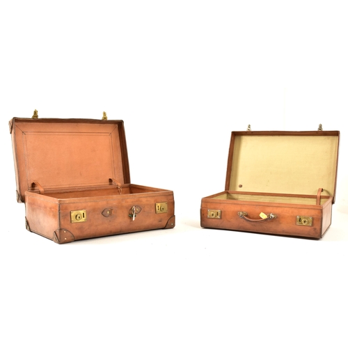 71 - A pair of vintage late 20th century pig skin leather travelling suitcases. Each suitcase of rectangu... 