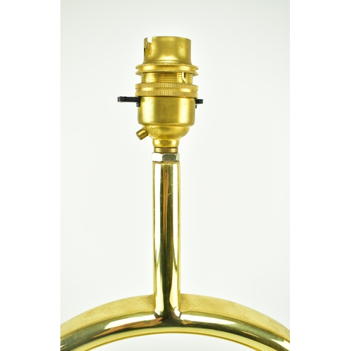 122 - A 1970s French tubular brass table lamp in the manner of Jacques Adnet. Brass plinth base of rectang... 