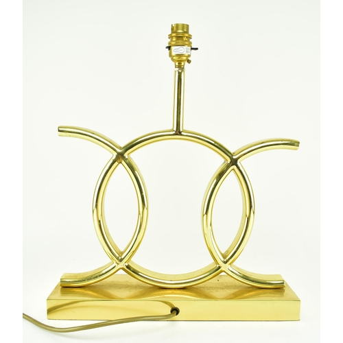 122 - A 1970s French tubular brass table lamp in the manner of Jacques Adnet. Brass plinth base of rectang... 