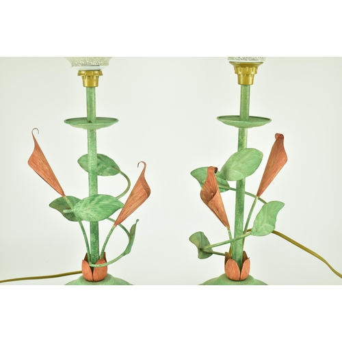 125 - A pair of 20th century French toleware painted metal table lamps. Each with green painted metal fram... 