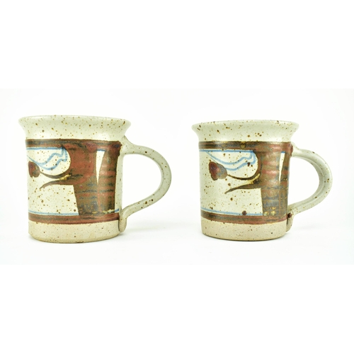 356 - Eden Pottery - A pair of 20th century studio art pottery cups. Each of typical form with abstract gl... 