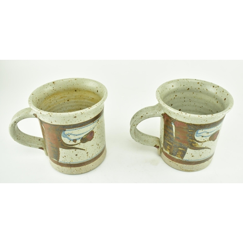 356 - Eden Pottery - A pair of 20th century studio art pottery cups. Each of typical form with abstract gl... 