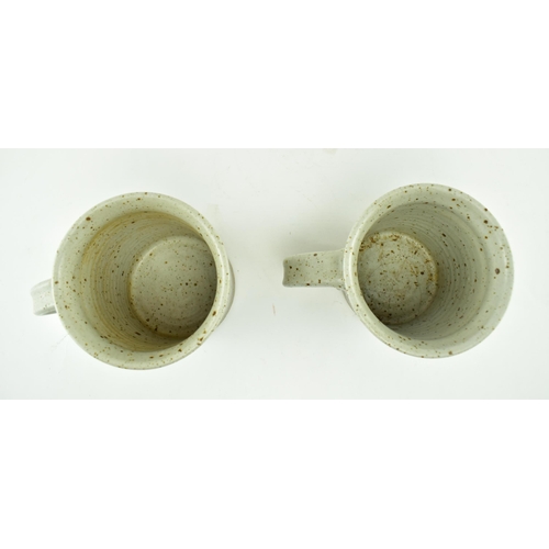 356 - Eden Pottery - A pair of 20th century studio art pottery cups. Each of typical form with abstract gl... 