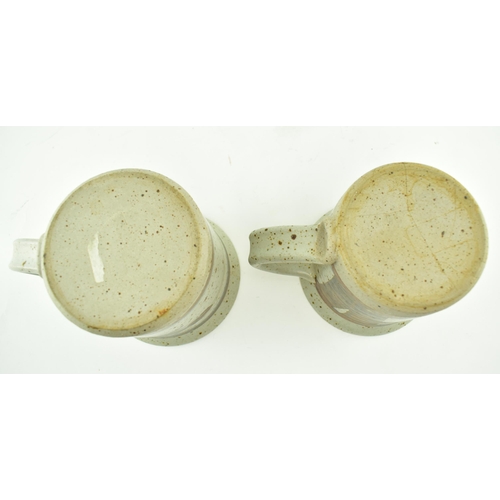 356 - Eden Pottery - A pair of 20th century studio art pottery cups. Each of typical form with abstract gl... 