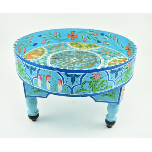 469 - A vintage 20th century hand painted Moroccan low table. The table having a circular top with raised ... 