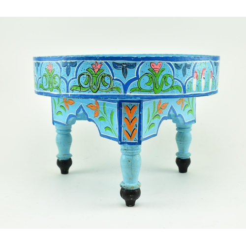 469 - A vintage 20th century hand painted Moroccan low table. The table having a circular top with raised ... 