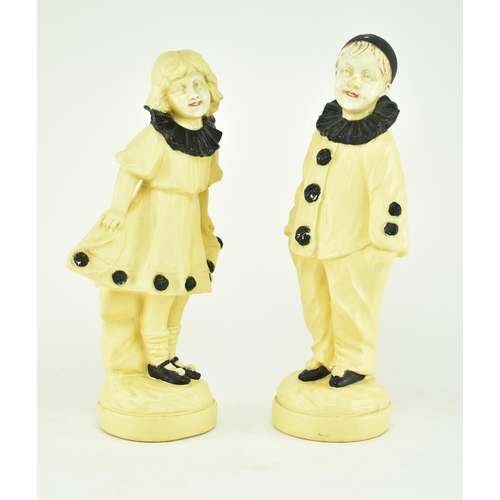 523 - A plaster Art Deco 1930s mantlepiece clock and garniture set, in a clown theme. The central clock fe... 