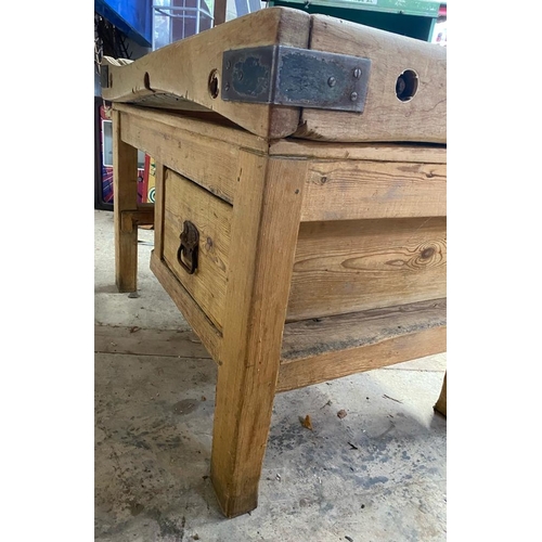 17 - An early 20th century large iron bound butcher's block. Raised on a chucky pine base set with a sing... 