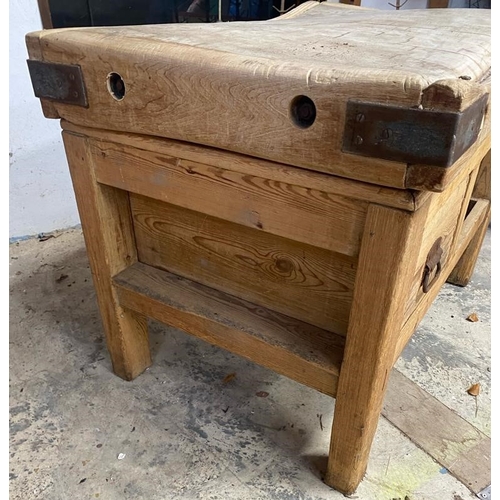 17 - An early 20th century large iron bound butcher's block. Raised on a chucky pine base set with a sing... 