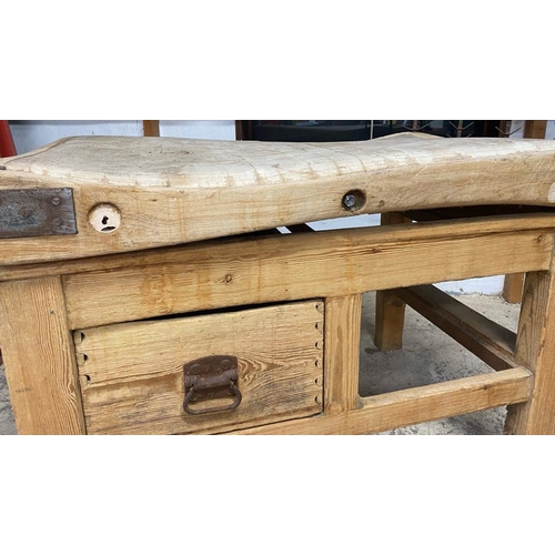 17 - An early 20th century large iron bound butcher's block. Raised on a chucky pine base set with a sing... 