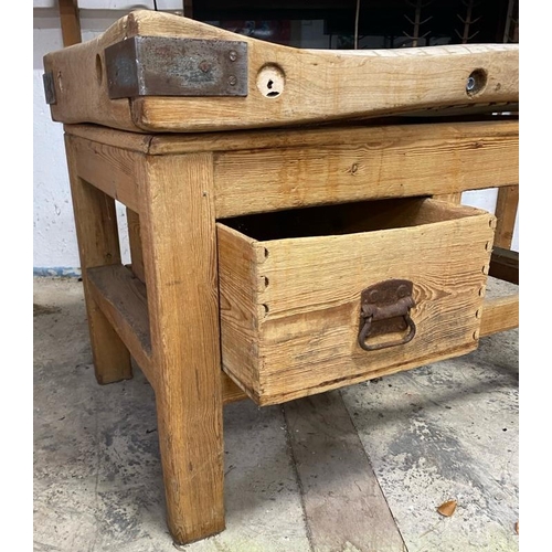 17 - An early 20th century large iron bound butcher's block. Raised on a chucky pine base set with a sing... 