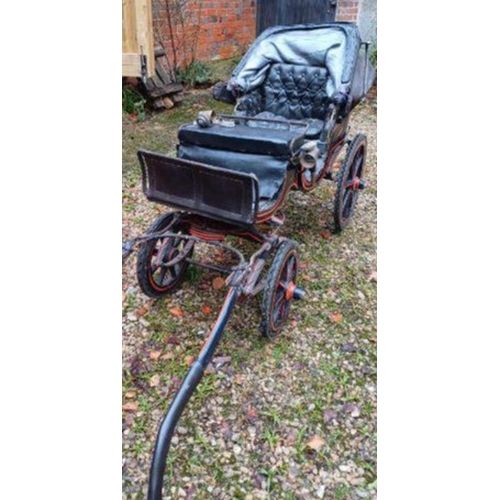 300 - A late 19th century Victorian child's four wheel dog / goat cart. The driver's seat flanked by a pai... 