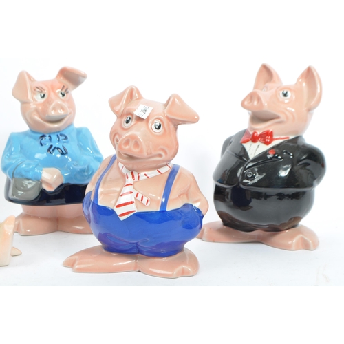 105 - Wade - A collection of five 20tgh century Wade ceramic Natwest pig money banks / piggie banks. Four ... 
