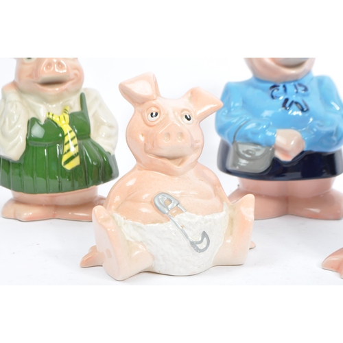 105 - Wade - A collection of five 20tgh century Wade ceramic Natwest pig money banks / piggie banks. Four ... 