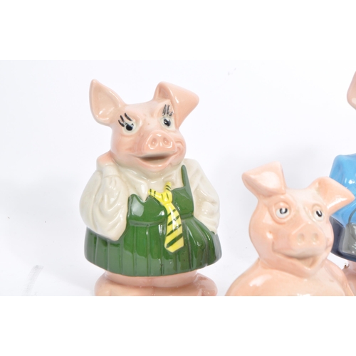 105 - Wade - A collection of five 20tgh century Wade ceramic Natwest pig money banks / piggie banks. Four ... 