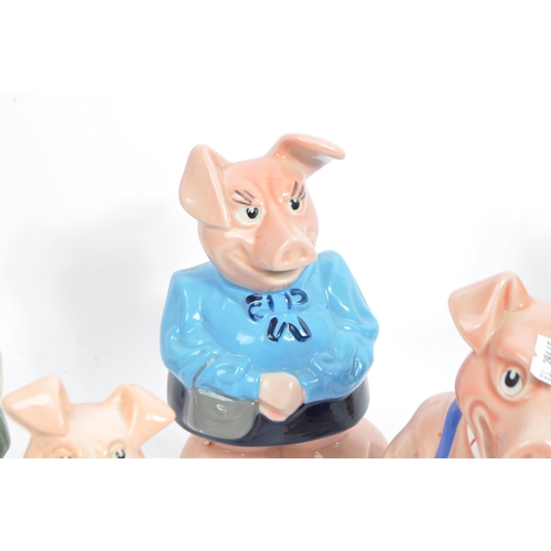 105 - Wade - A collection of five 20tgh century Wade ceramic Natwest pig money banks / piggie banks. Four ... 