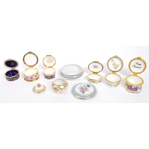 15 - A collection of 14 lidded enamel and porcelain trinket boxes / pots from Halcyon Days, Fenton China ... 