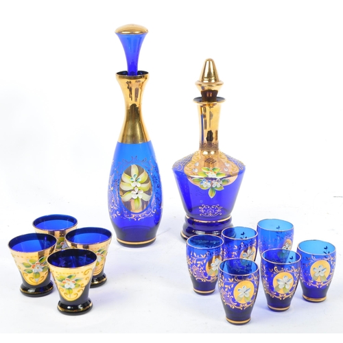 16 - Two Czech Bohemian art glass decanters and glasses in cobalt blue, with hand painted / applied gilt ... 