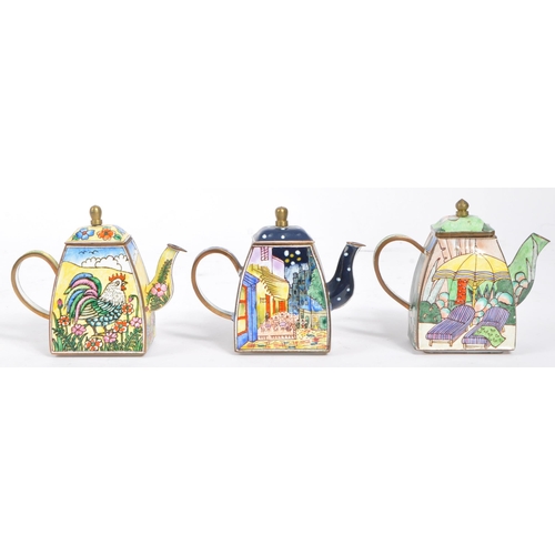 18 - A collection of six ' Trade + Aid ' miniature enamelled brass teapots. These little teapots come in ... 