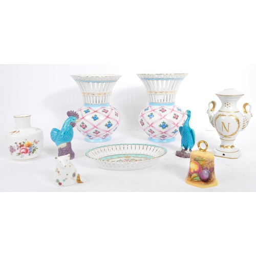 19 - Three pieces of Limoges Porcelain to include: a pair of urns / vases with white ground, decorated in... 