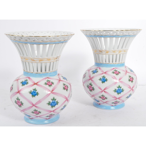 19 - Three pieces of Limoges Porcelain to include: a pair of urns / vases with white ground, decorated in... 